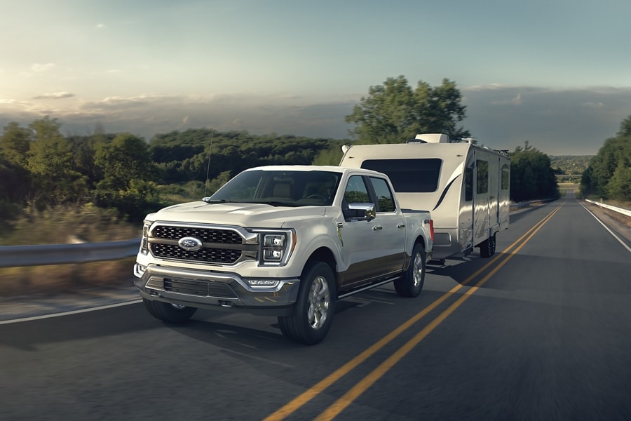 2022 F-150® King Ranch™ in Oxford White pulling a camper