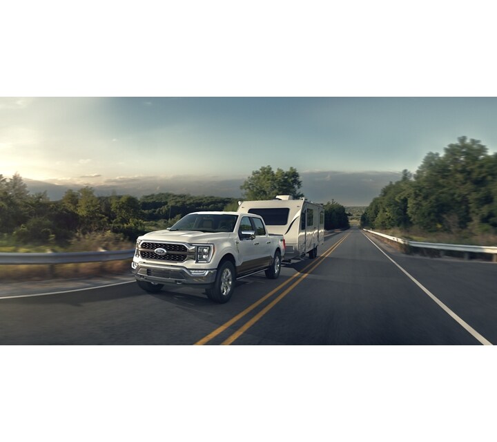 2023 F-150® King Ranch™ in Oxford White pulling a camper