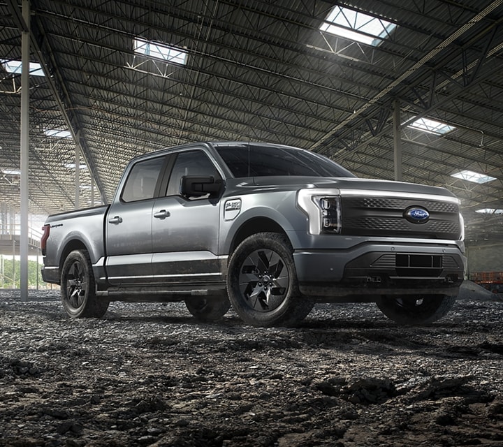2022 Ford F-150® Lightning™ in Iconic Silver parked inside a new construction building