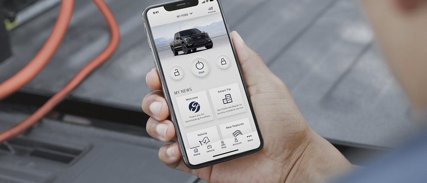 Close-up of hand holding a smartphone showing the FordPass™ App