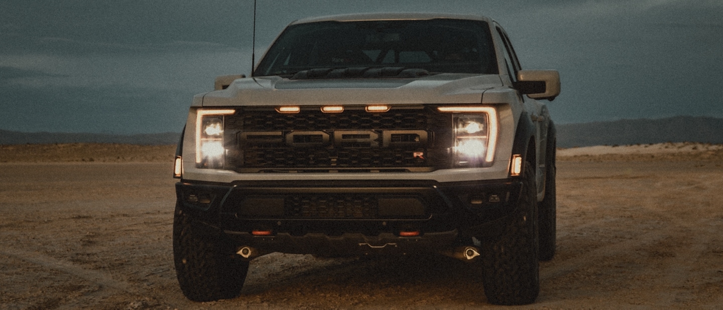 2023 Ford F-150® Raptor® R parked in the desert showing grille and headlights 