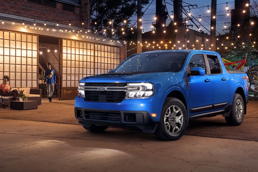 A Ford Maverick is parked on a patio under lights