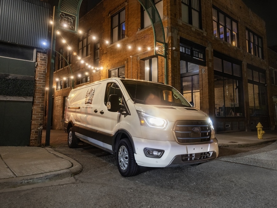 2026 Ford E-Transit™ Cargo Van pulling out of an alley in between buildings
