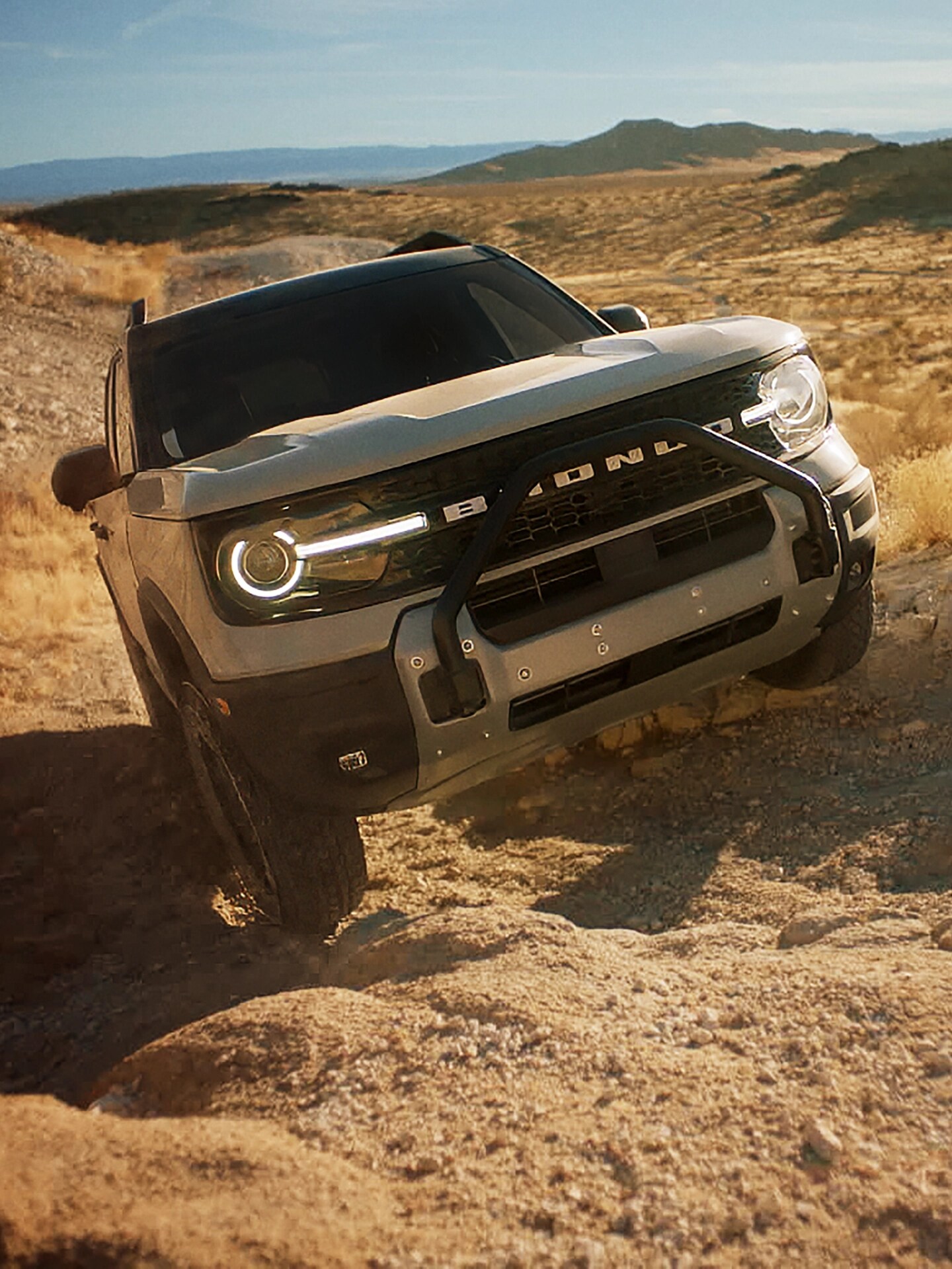 Bronco Sport driving on rugged terrain.