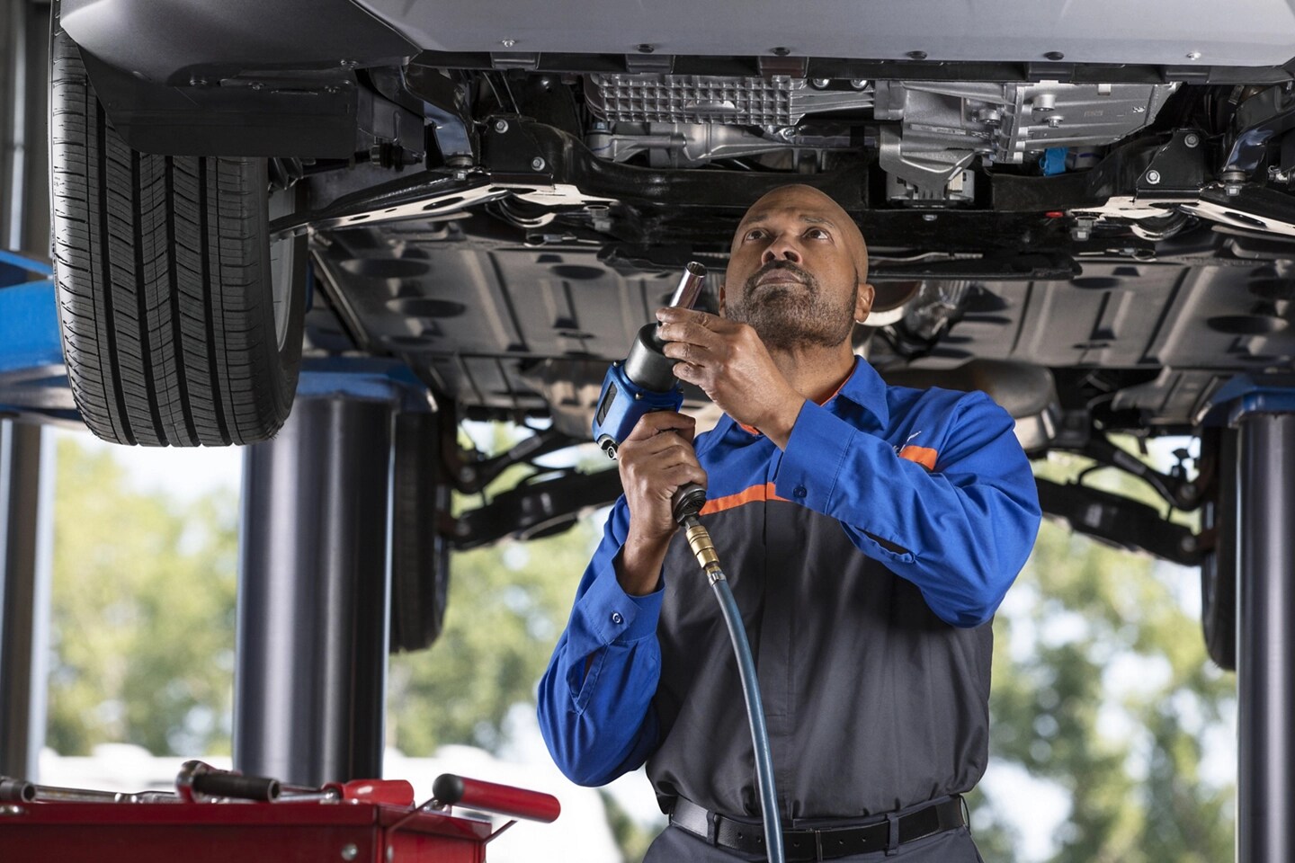 A Ford Service garage with a man performing maintenance on a Ford vehicle