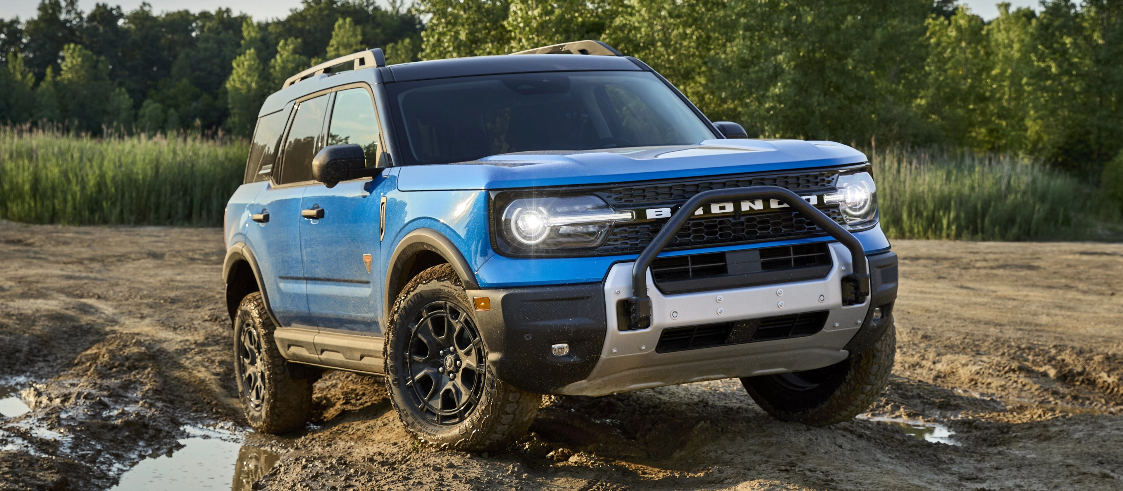 2025 Ford Bronco Sport® being driven in the dirt and near a mud puddle