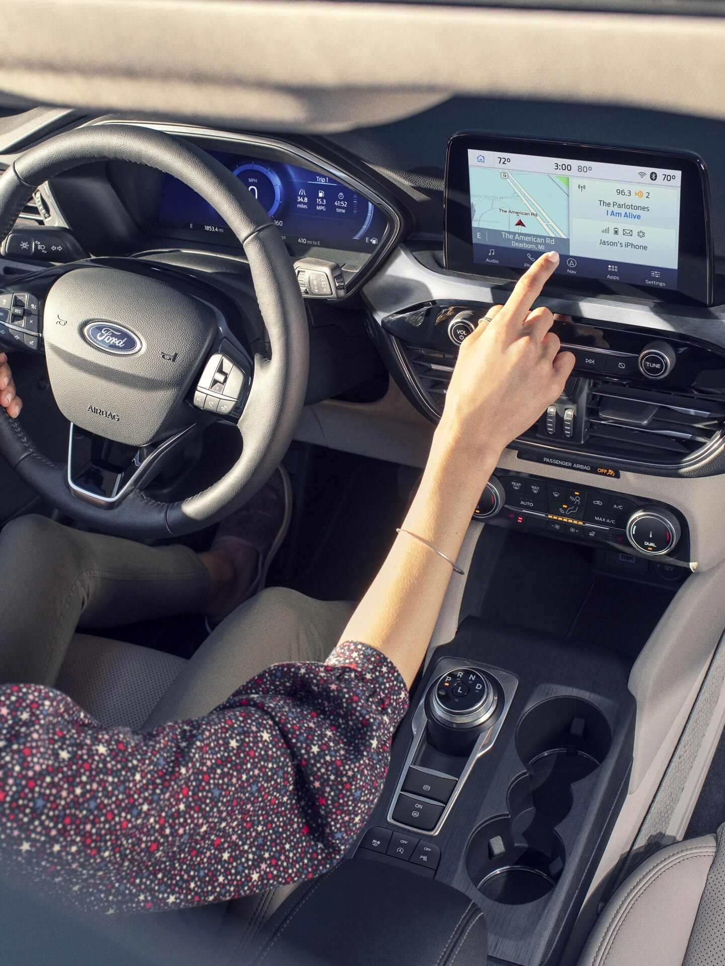 A woman driving a Ford vehicle