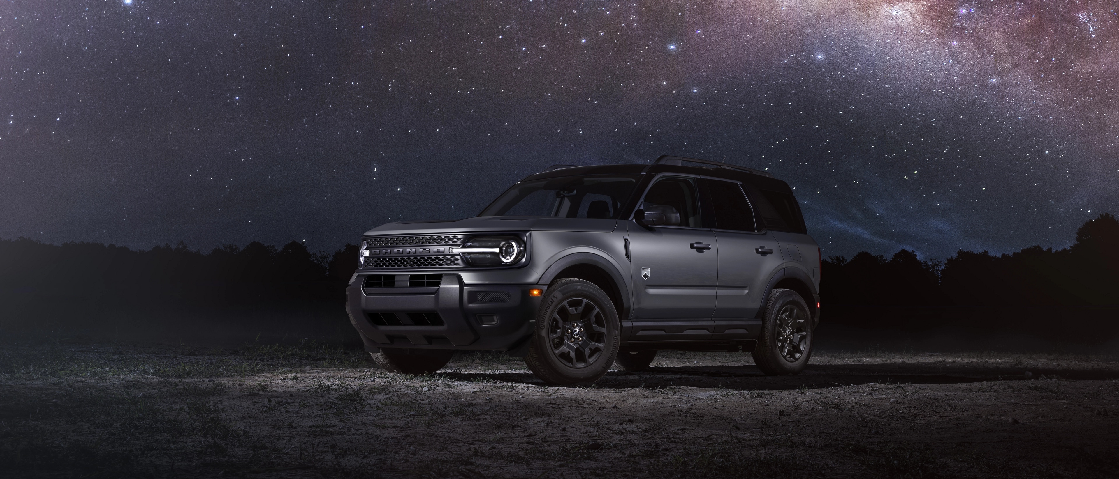 2025 Bronco Sport® Outer Banks model parked in front of a starry night sky