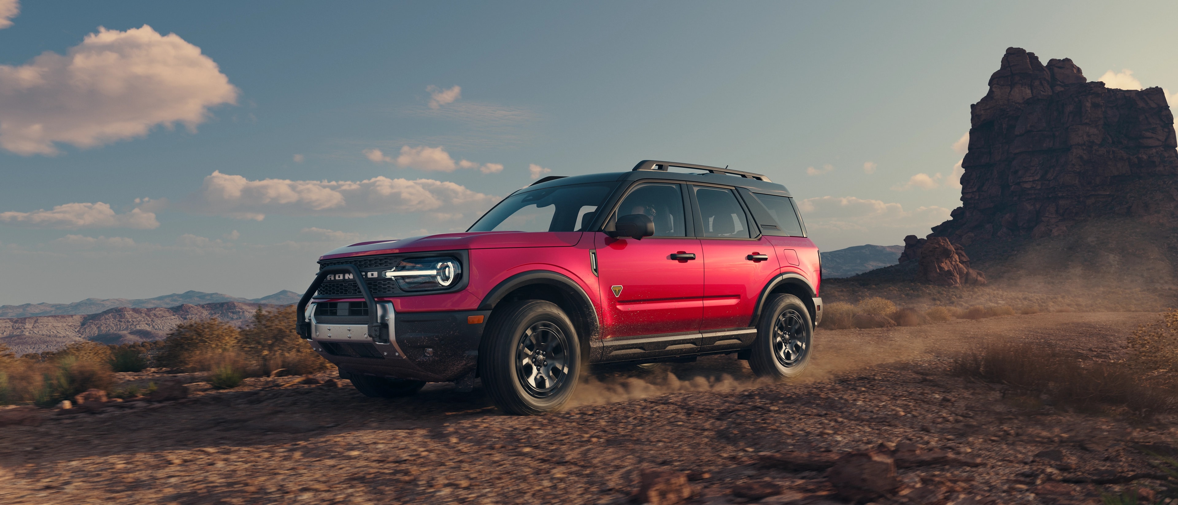2025 Ford Bronco Sport® being driven on a trail with mountains in background