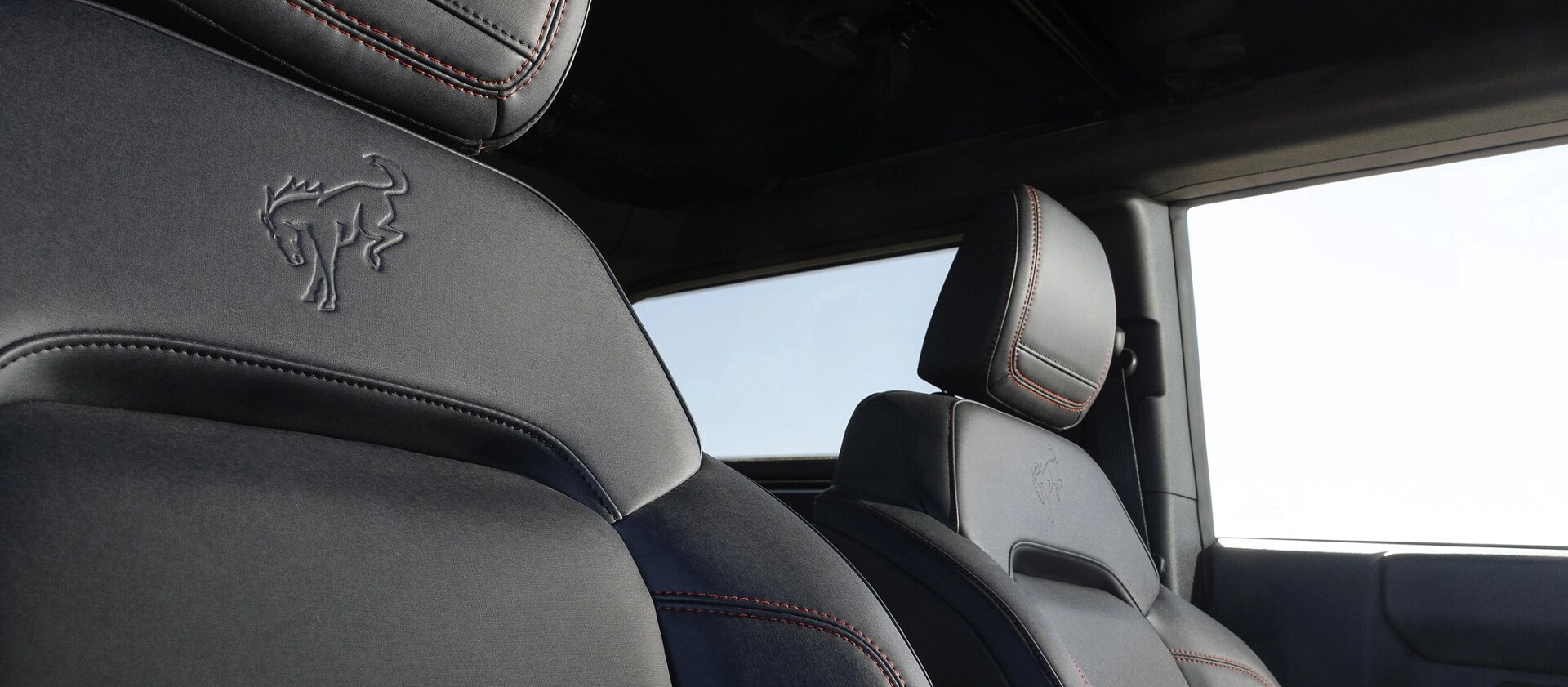 A close-up of the embossed emblem on the front seat upholstery of a 2025 Ford Bronco® Stroppe Edition SUV
