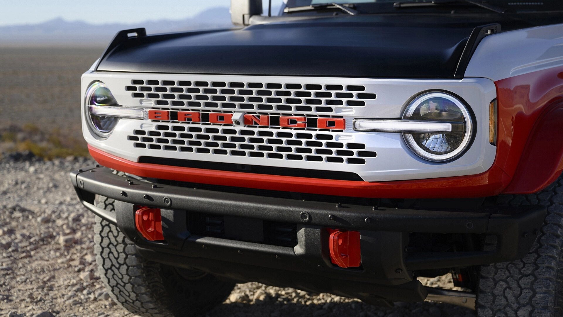 A front view of a 2025 Ford Bronco® Stroppe Edition SUV parked on a rocky landscape