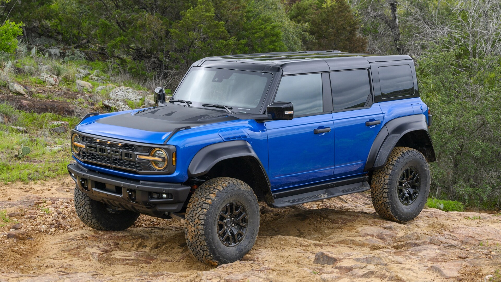 A 2025 Ford Bronco® SUV parked on a muddy hilltop in the forest