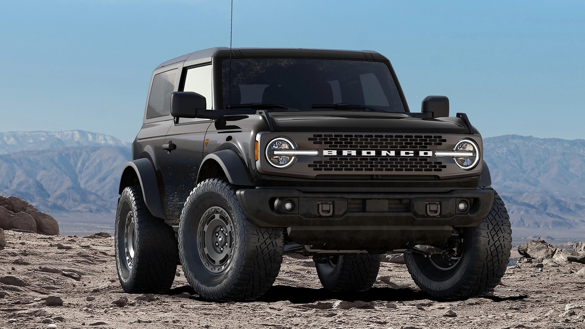 A 2025 Ford Bronco® SUV parked on a mud flat next to a canyon vista