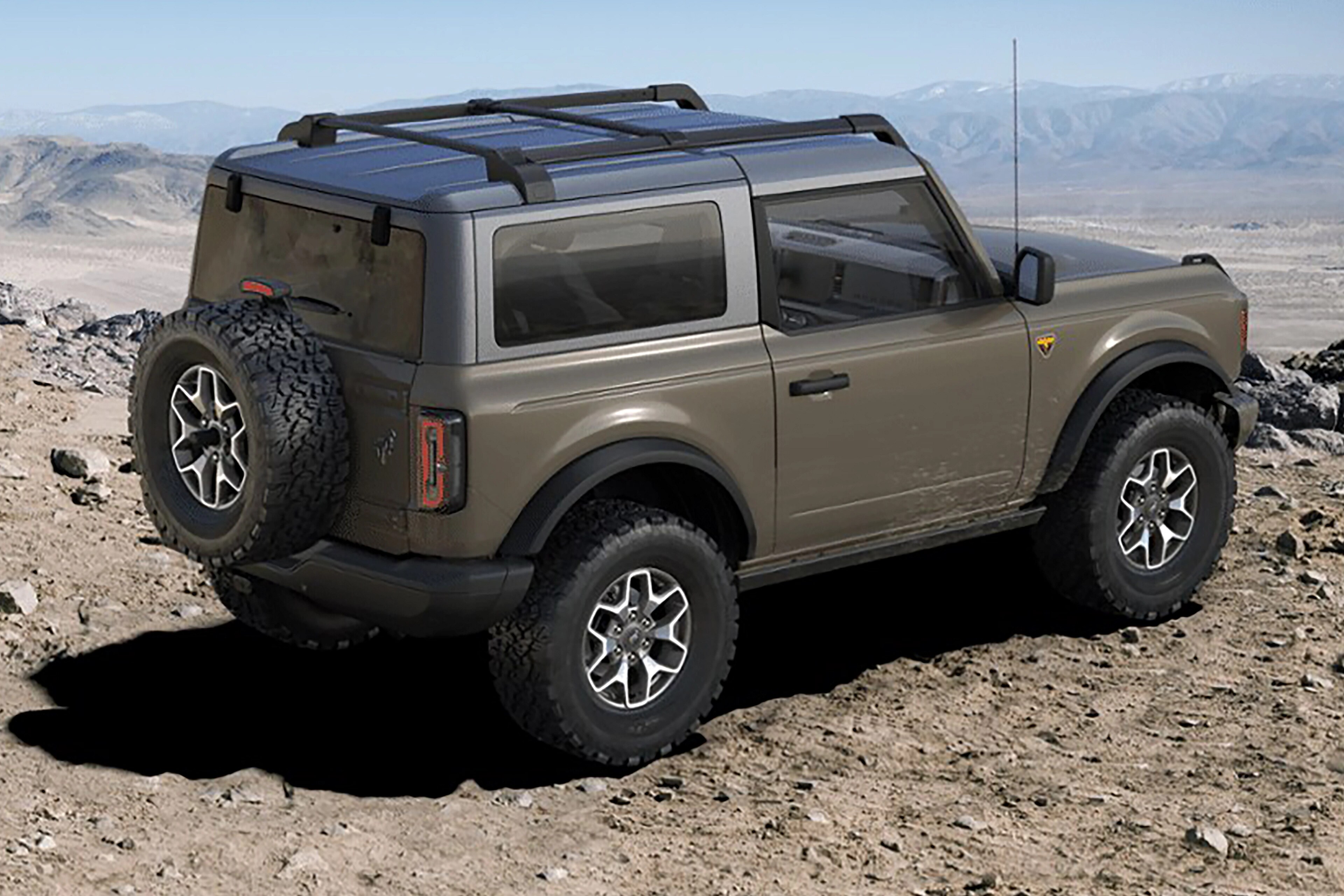 A 2025 Ford Bronco® SUV parked on a muddy mountaintop, with a hard top roof installed