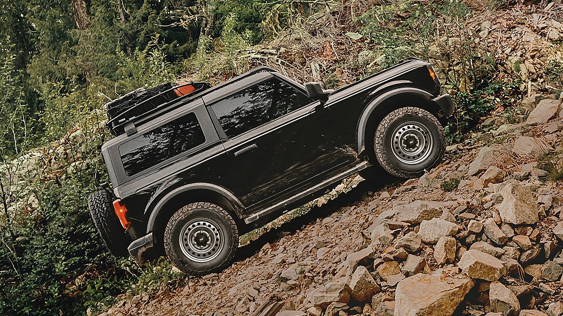 A 2025 Ford Bronco® SUV climbing a steep, rocky hill