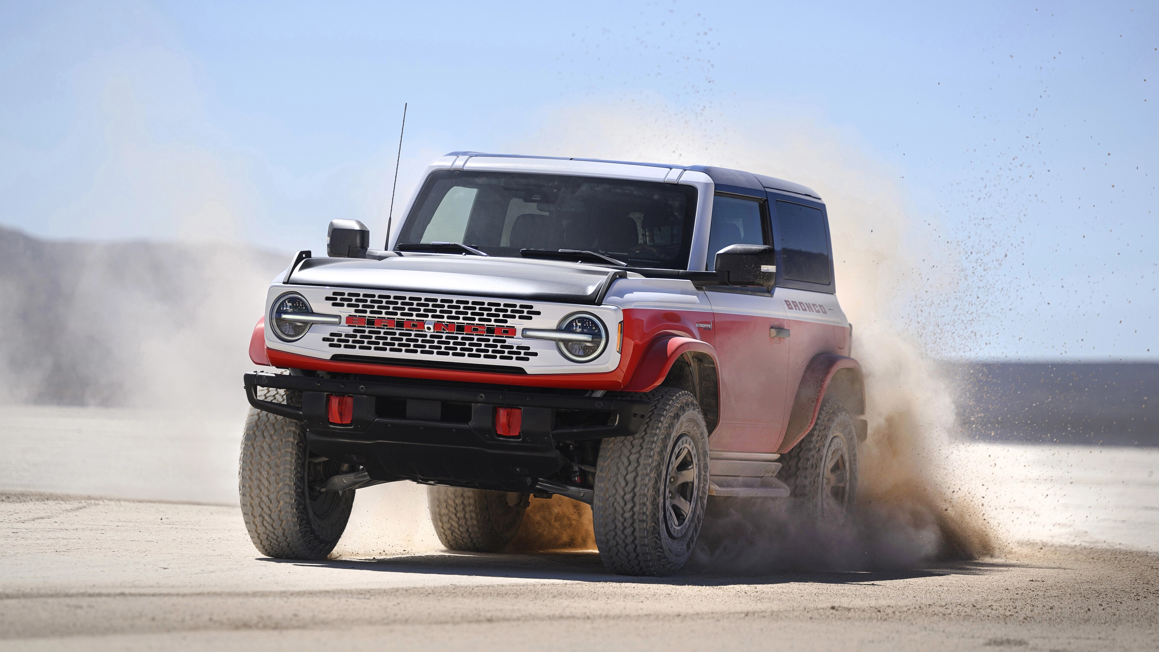A 2025 Ford Bronco® Stroppe Edition SUV kicking up sand on a beach