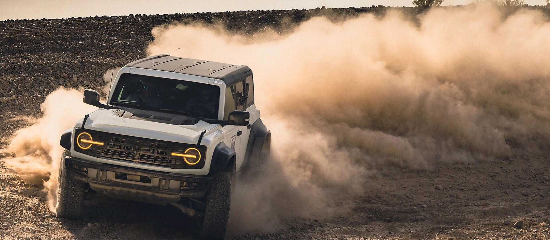 A 2026 Ford Bronco® Raptor® SUV kicking up dust in an empty field