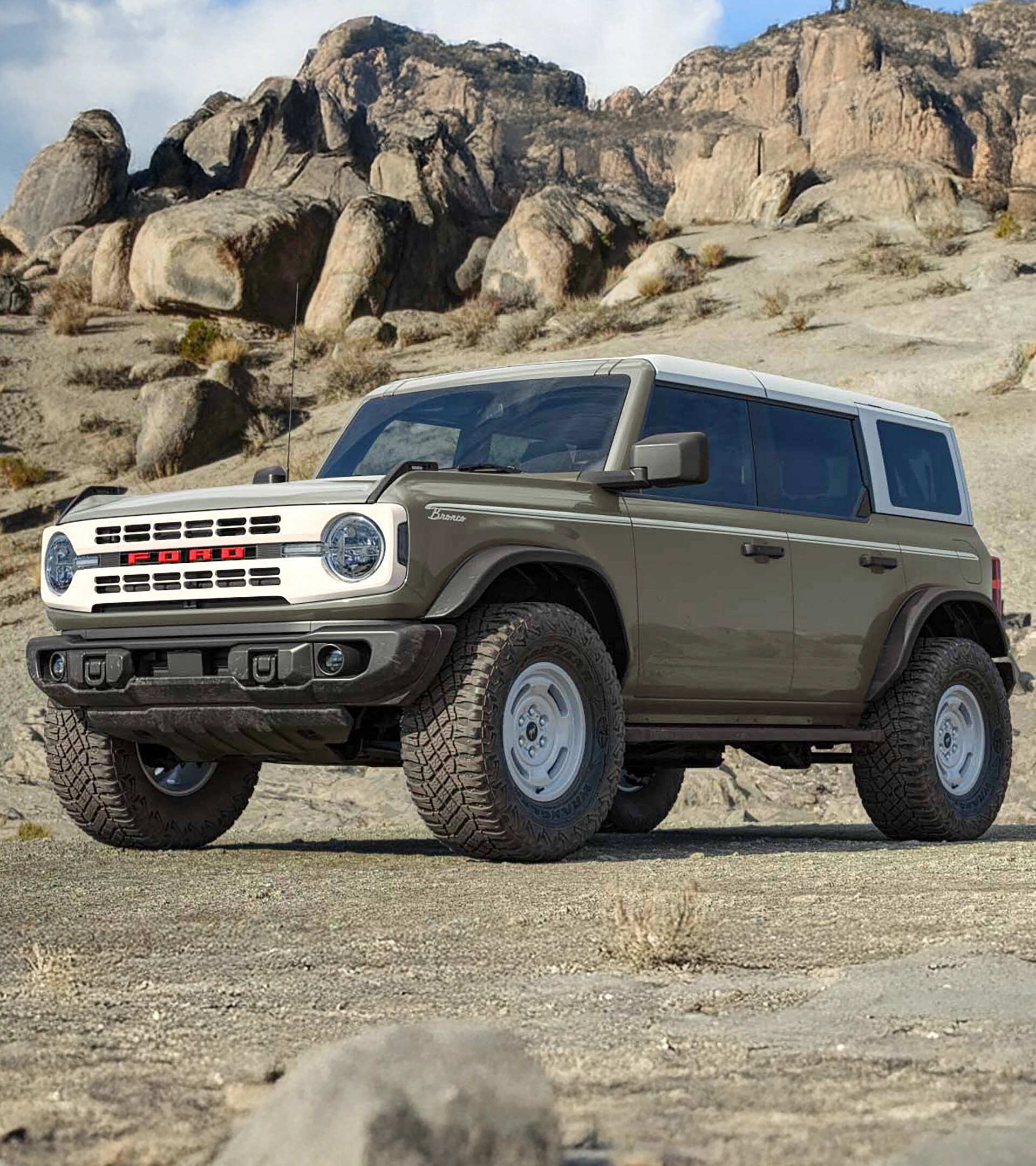 A 2026 Ford Bronco® Heritage Edition SUV parked on a mud flat, with a rocky cliff behind