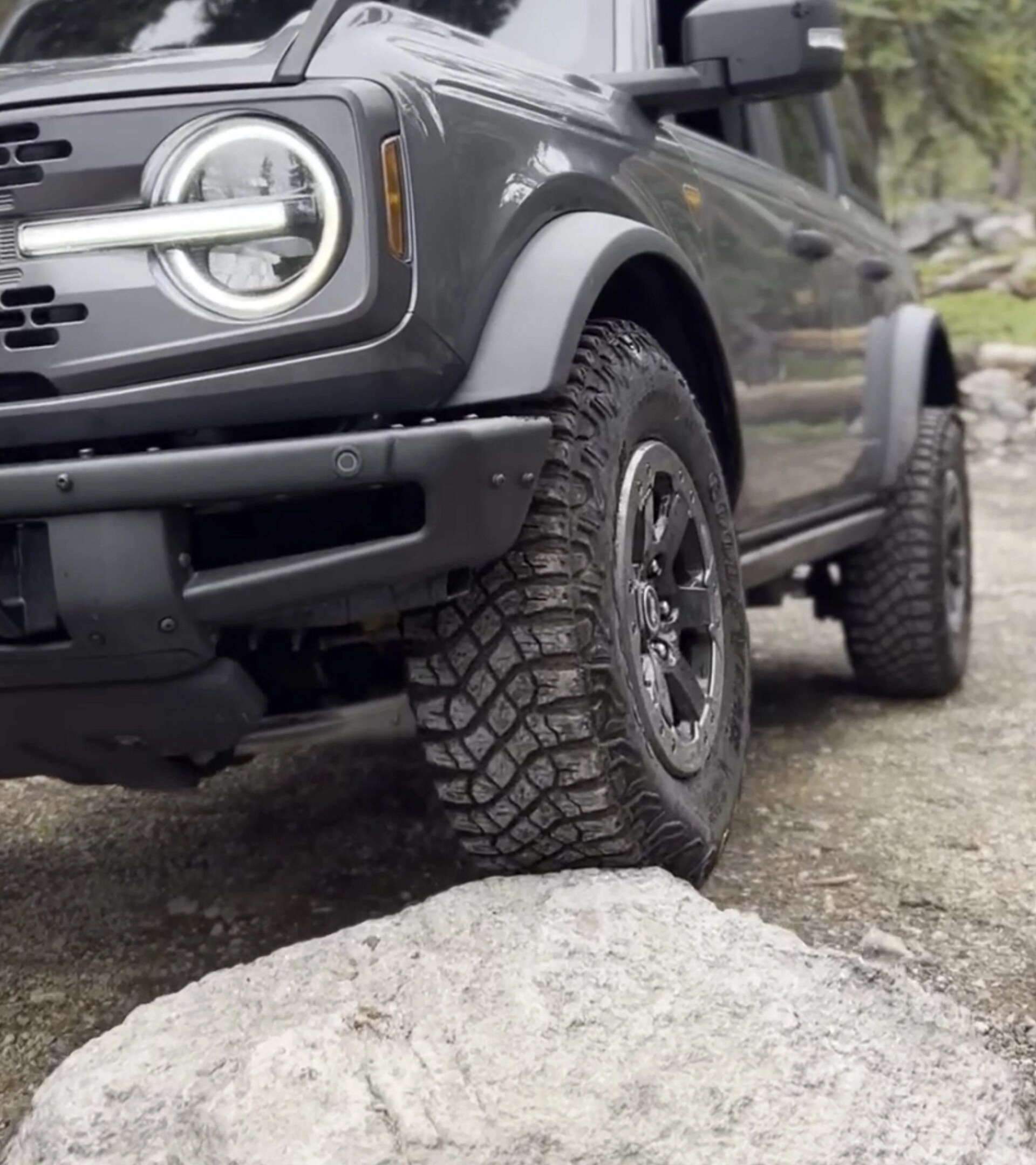 A 2026 Ford Bronco® SUV being driven onto a large boulder