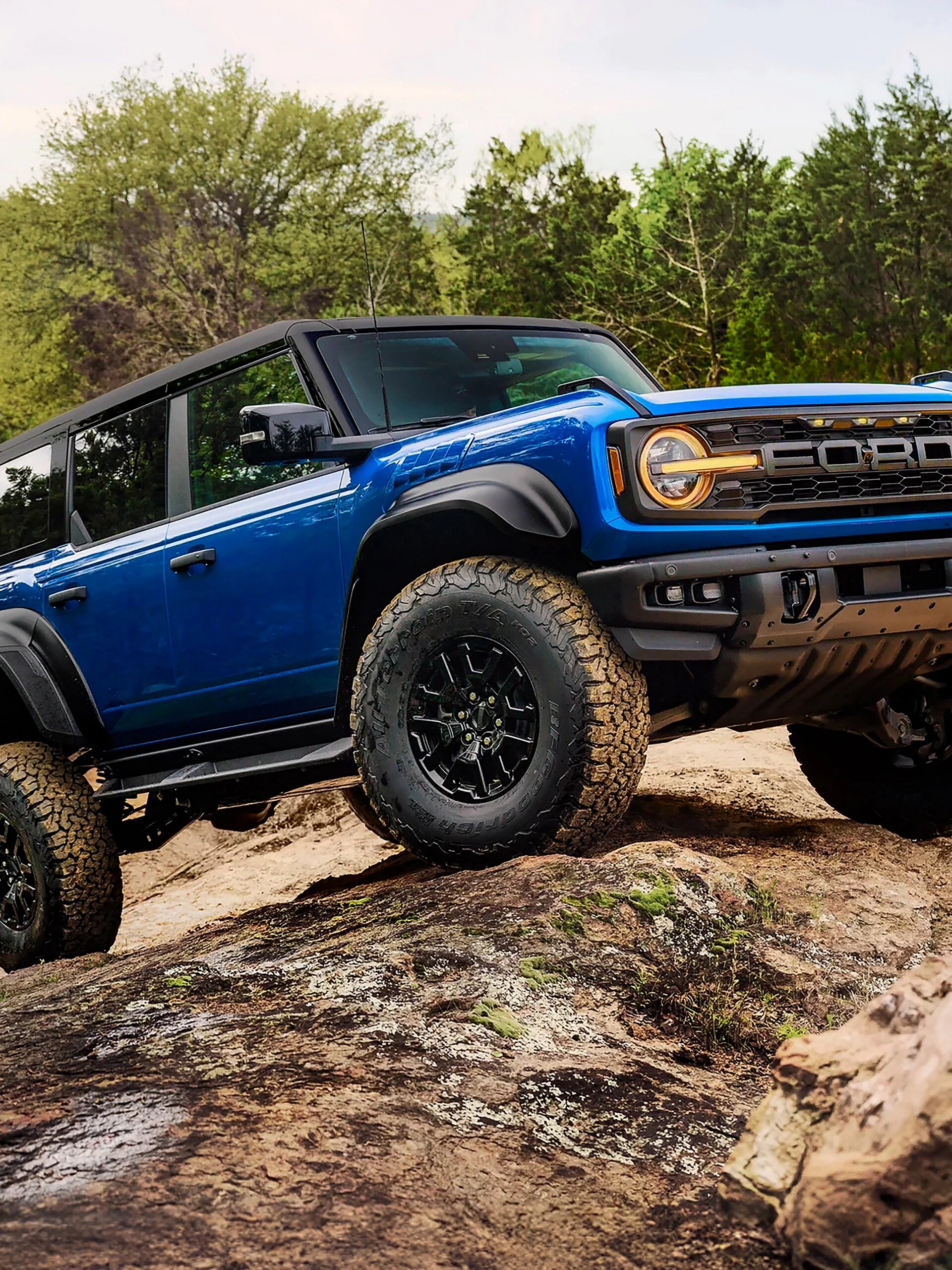 A 2026 Ford Bronco® Raptor® SUV with the available Raptor Black Appearance Package parked on a muddy landscape