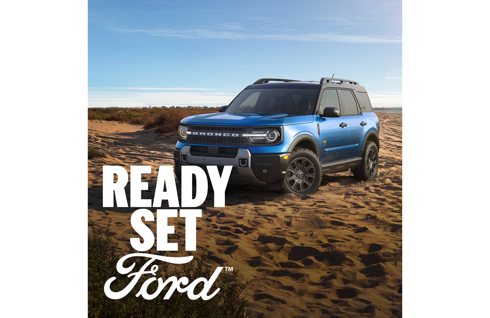 Three-quarter front view of a blue Ford Bronco Sport parked in a desert. White text “Ready Set Ford” appears in the lower left-hand corner. 