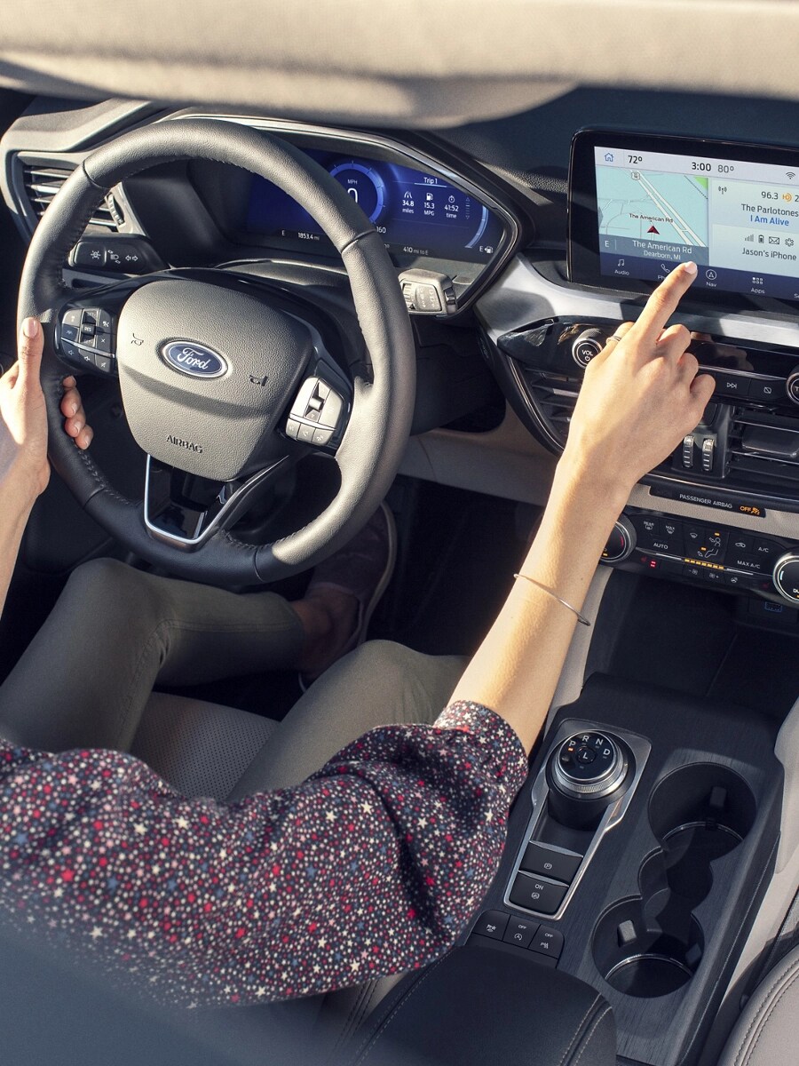 A woman driving a Ford vehicle