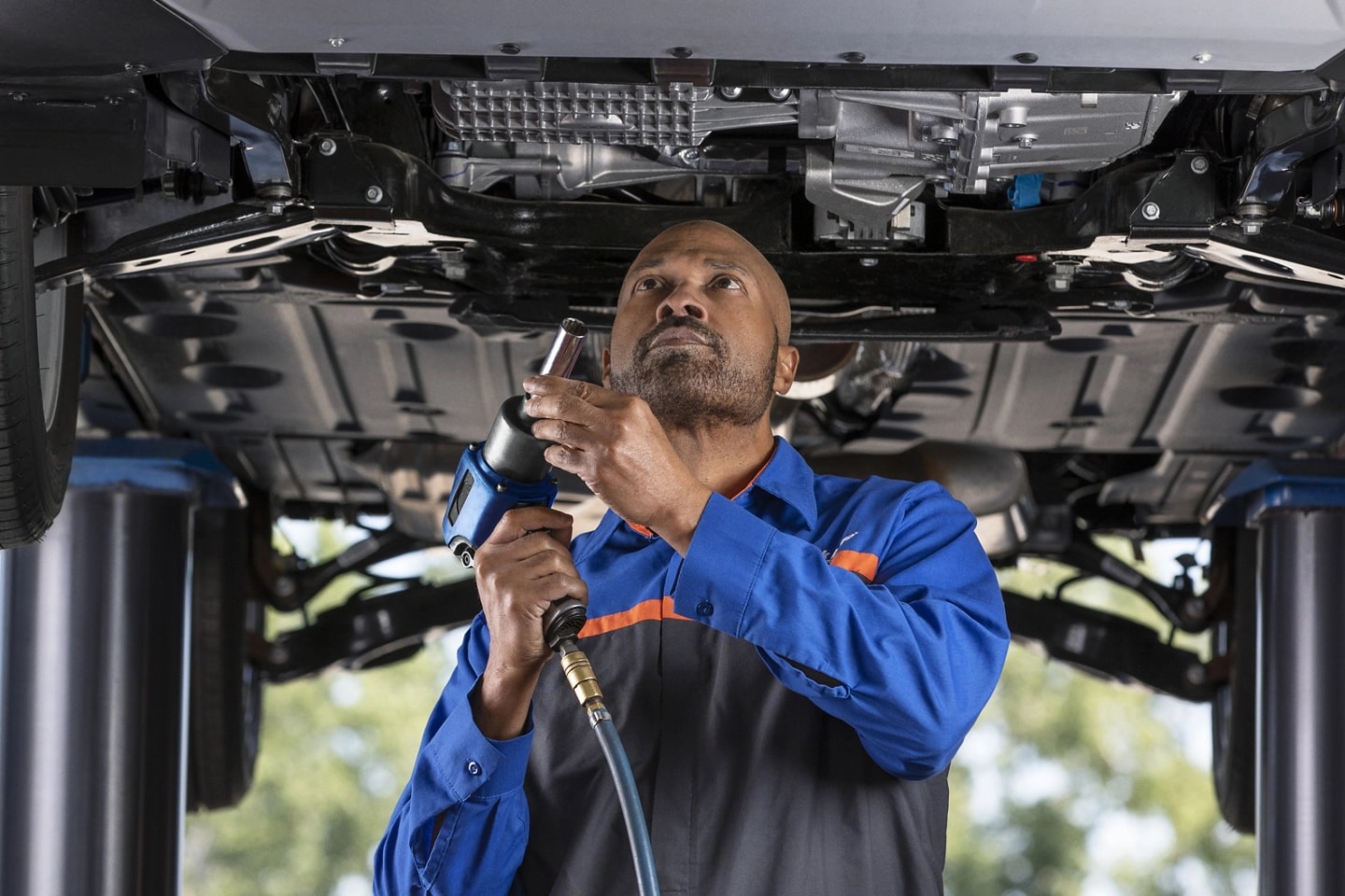 A Ford Service garage with a man performing maintenance on a Ford vehicle