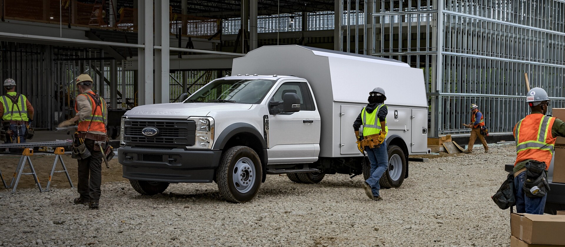 Workers using a 2026 Ford Super Duty® Chassis Cab with a utility box at construction site
