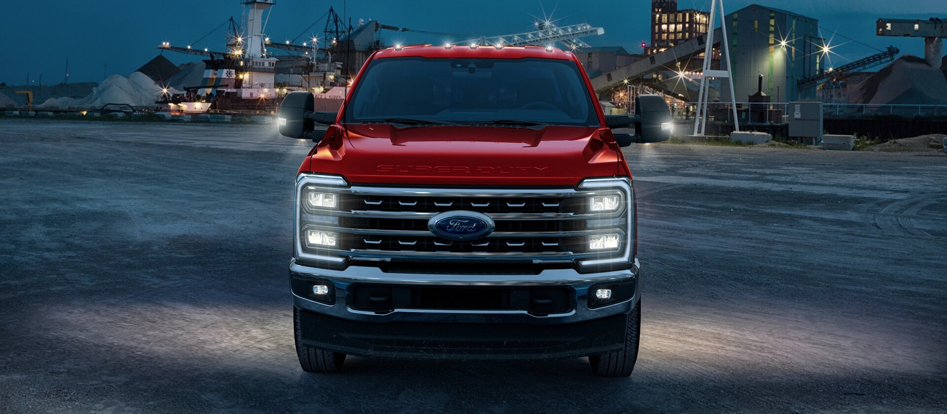 A 2026 Ford Super Duty® on a job site at night with all of the exterior lights on