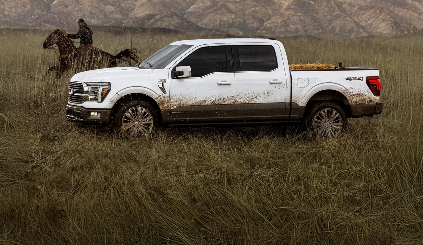 A 2025 Ford F-150® is shown driving down a country road.