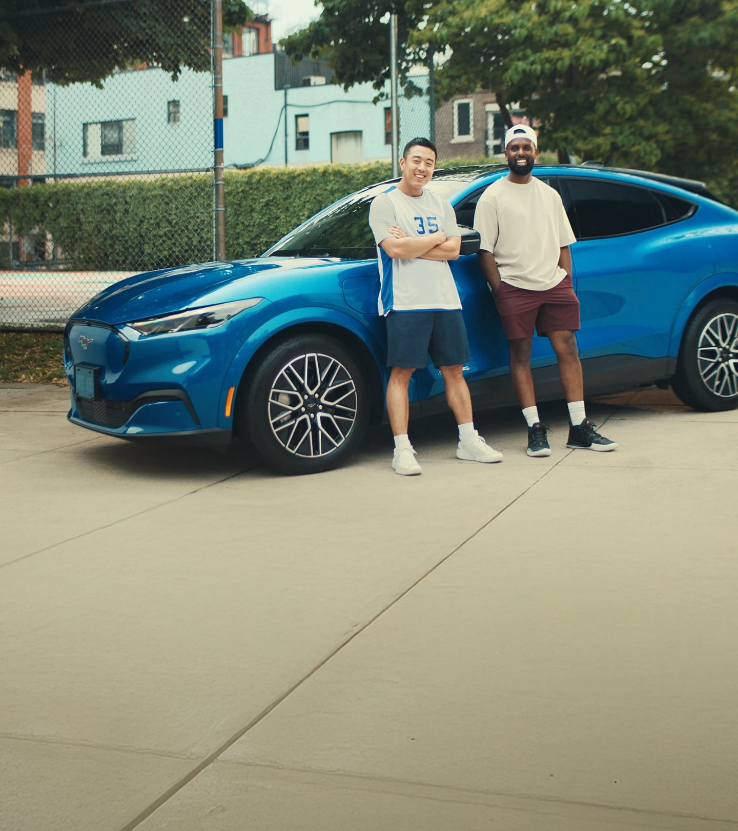 Two Ford of Canada Employees beside a 2025 Ford Mustang Mach-E®