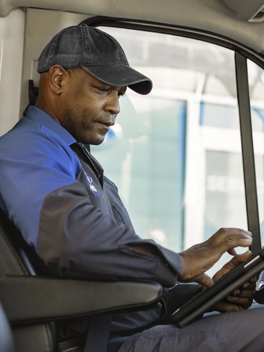 Ford technician sits in a vehicle.