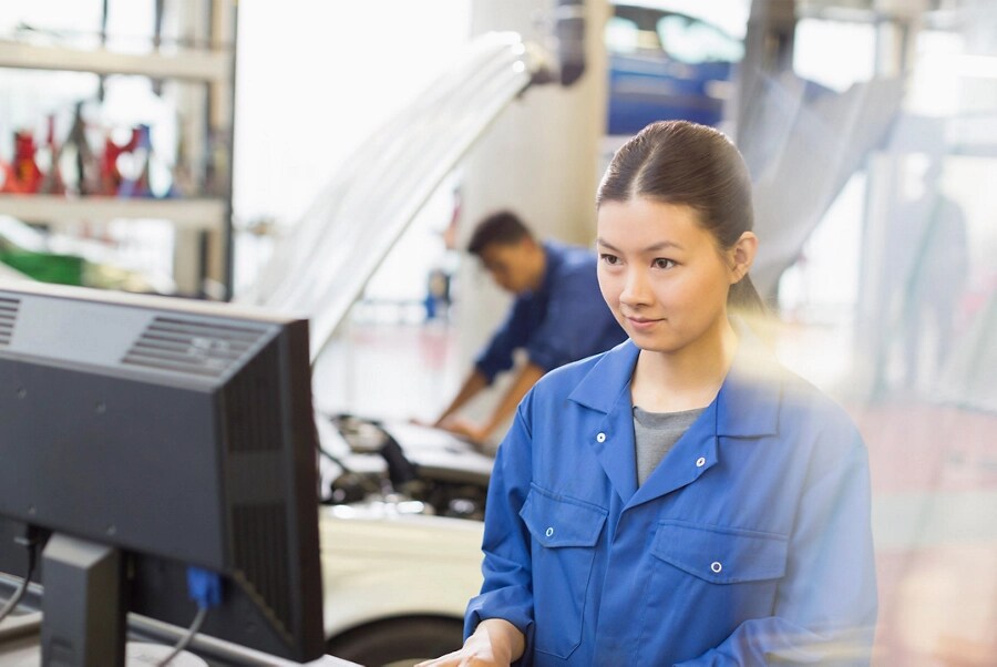 A Ford employee works at a computer.