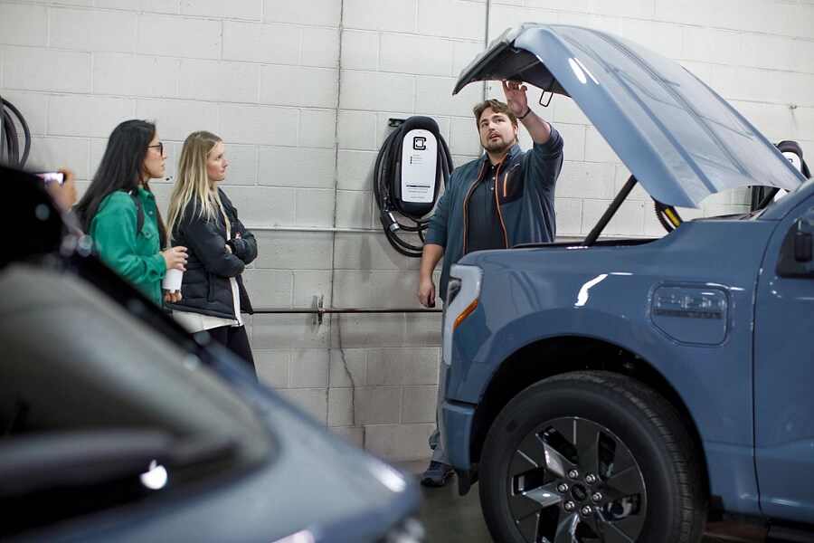 Ford instructor and two trainees inspect a Frunk on a Ford F-150 Lightning®.