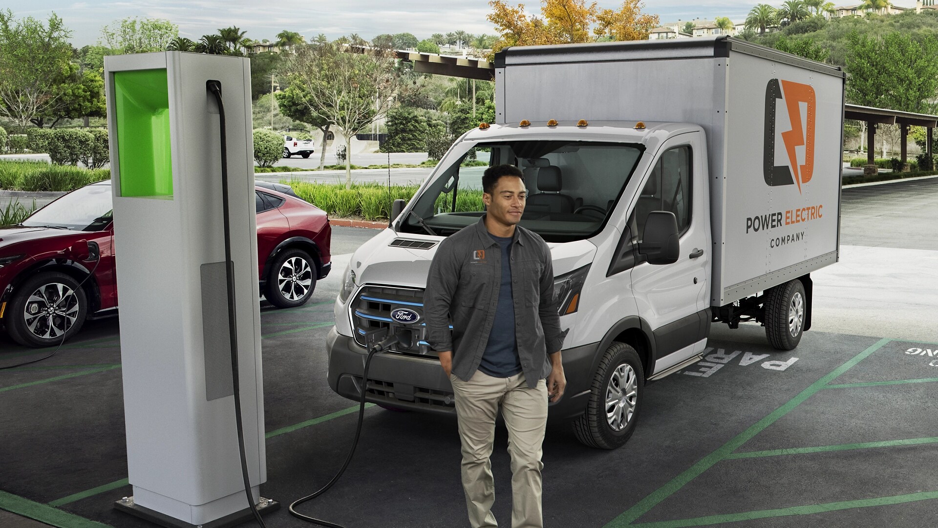 A white 2025 Ford E-Transit™ parked at a public charging station