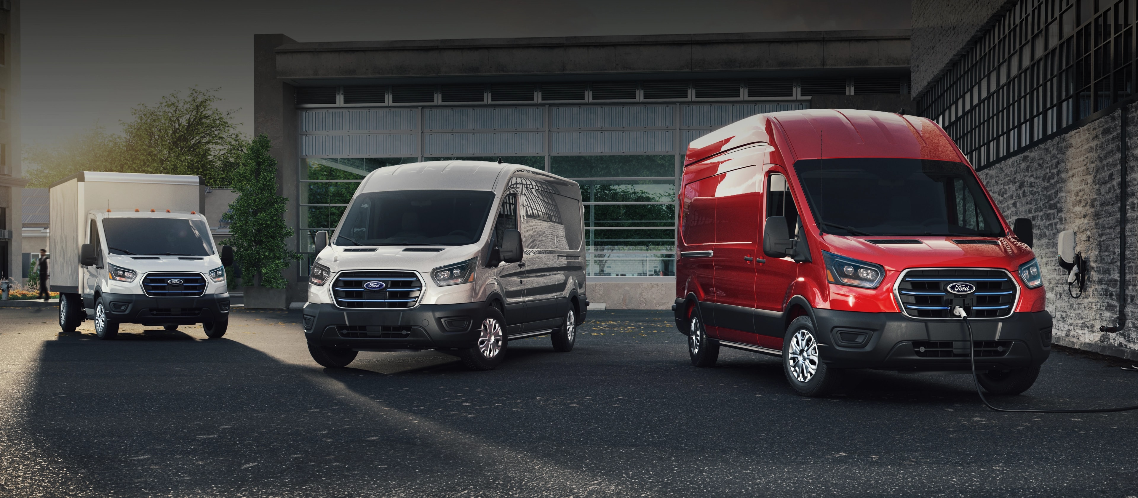 Three 2025 Ford E-Transit™ vehicles parked in a business lot