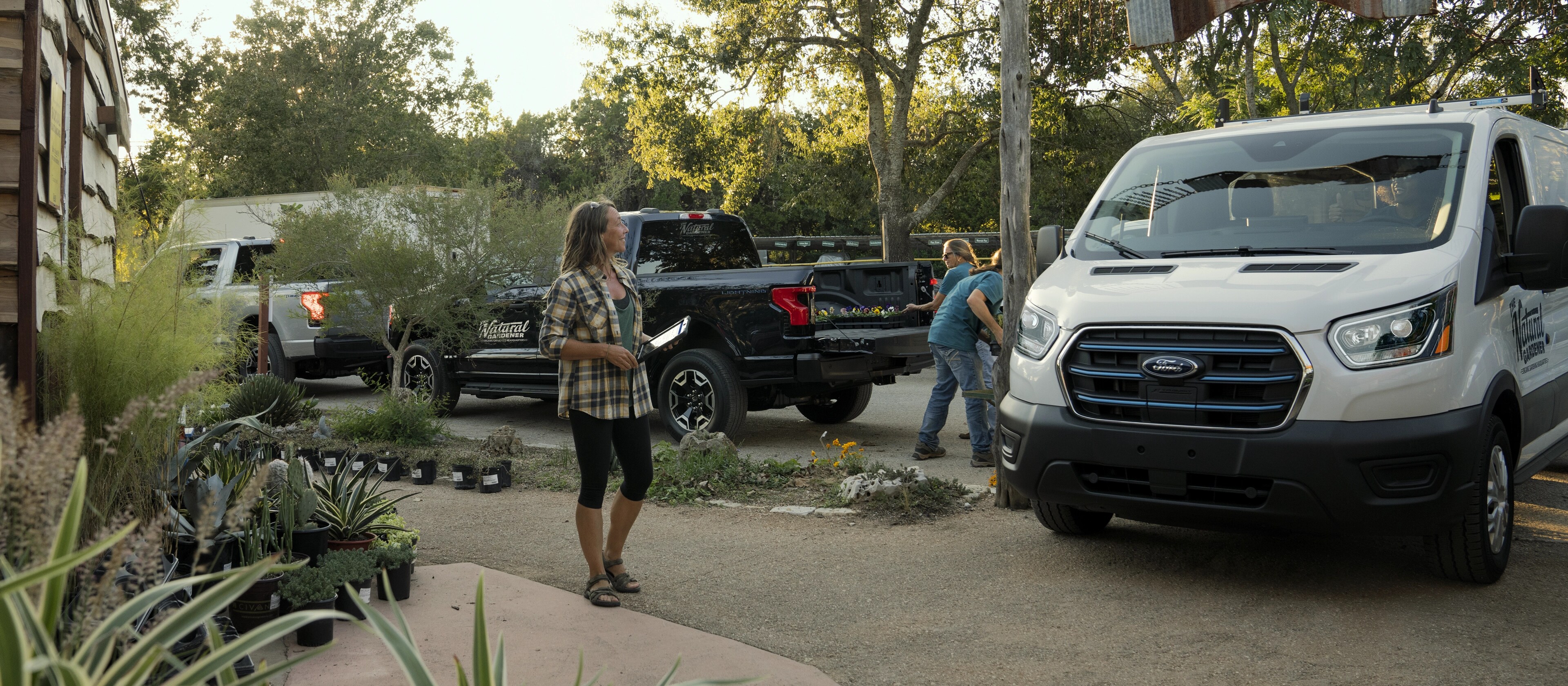 A white 2025 Ford E-Transit™ van parked and being loaded at a garden nursery