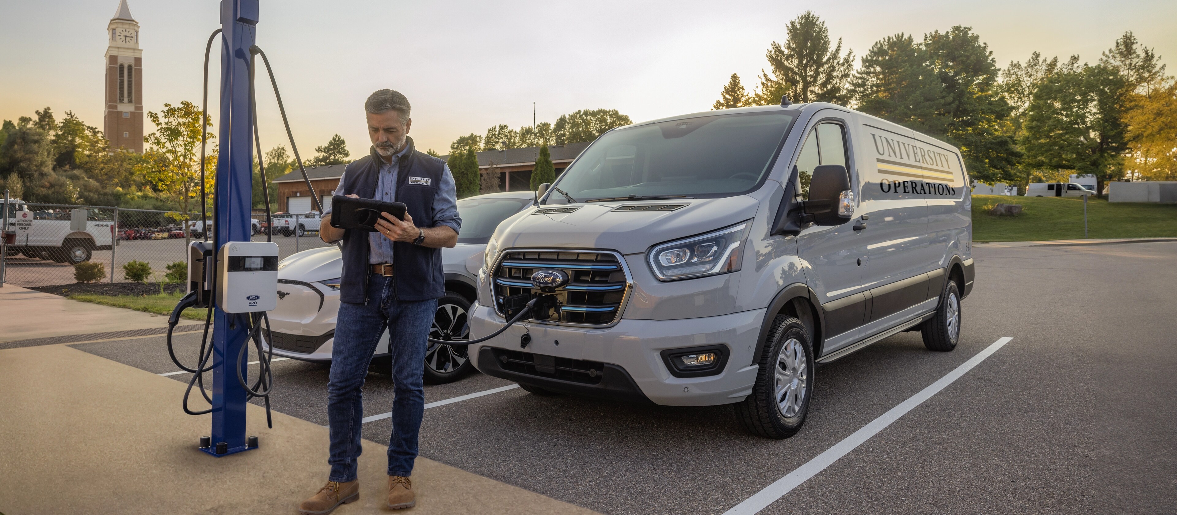 A white 2025 Ford E-Transit™ van parked at a public charging station