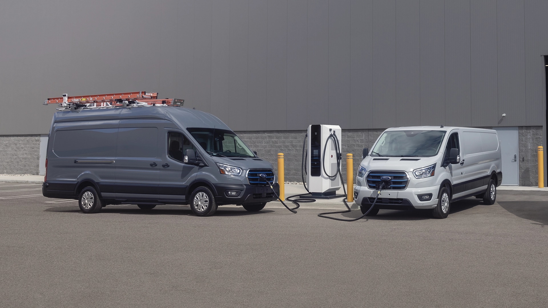 Two 2025 Ford E-Transit™ vahicle parked at a public charging station