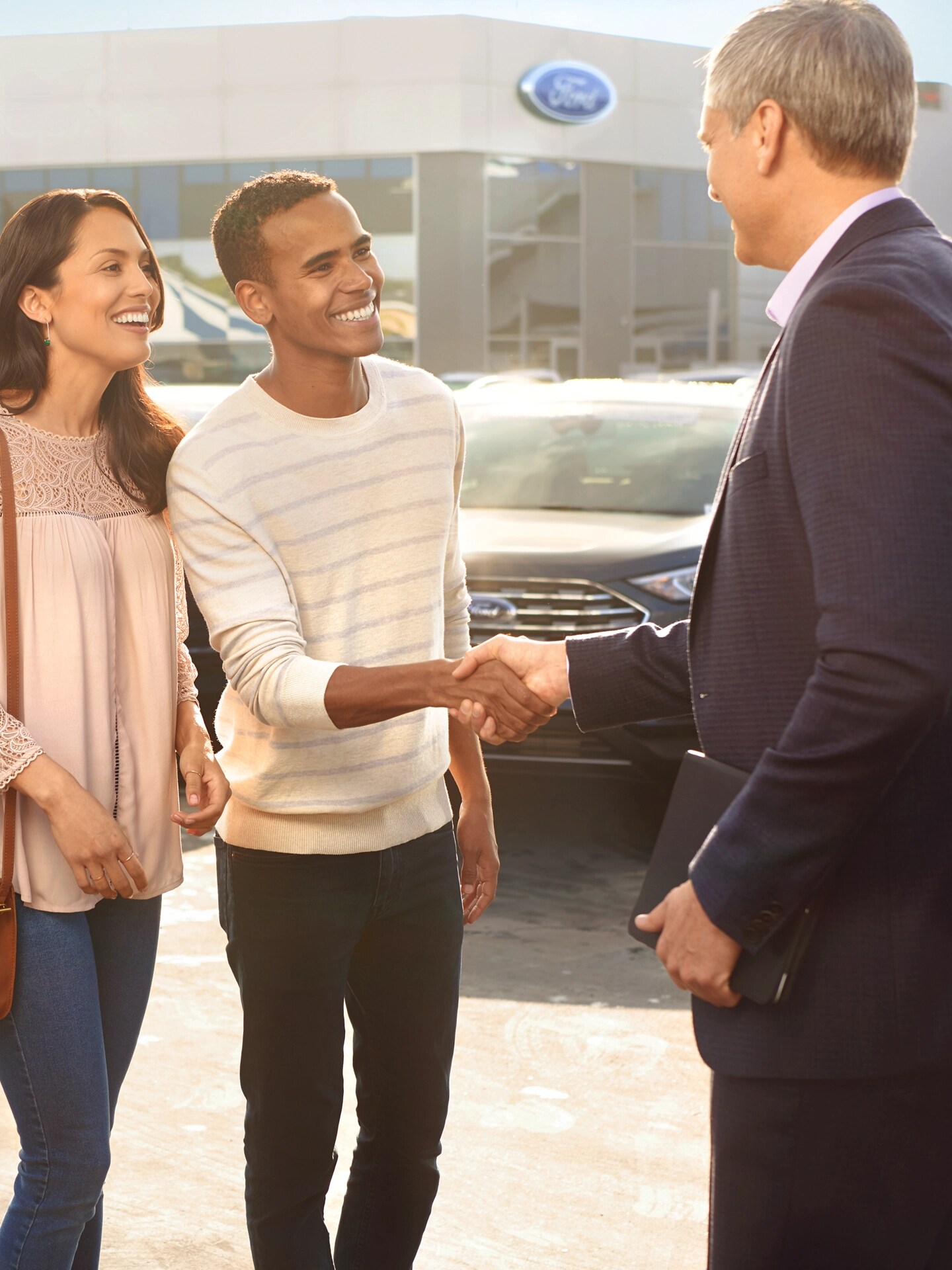 A couple speaking to a Ford technician. 