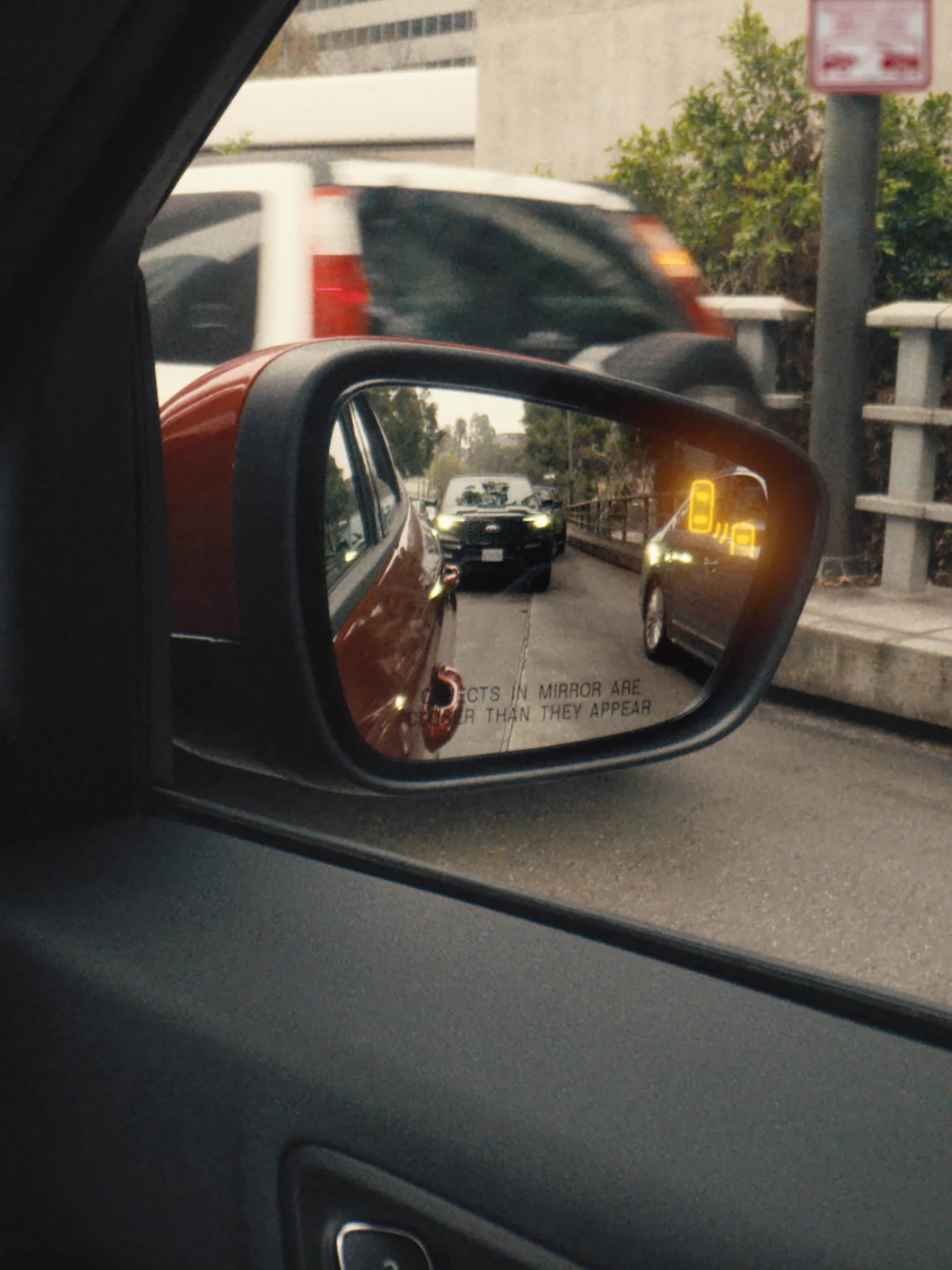 Blind Spot Information System (BLIS®) being activated on the side view mirror of a 2025 Ford Escape® SUV