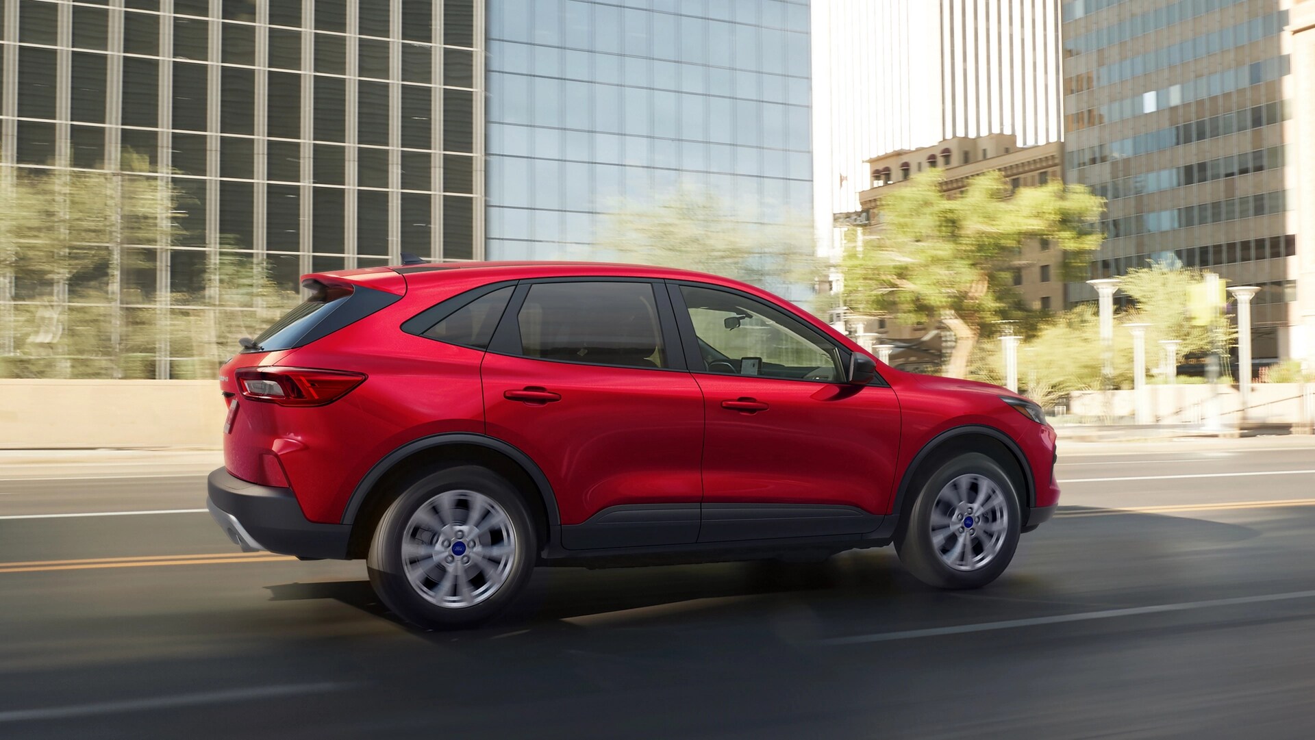 2026 Ford Escape® SUV in Rapid Red being driven on a city street