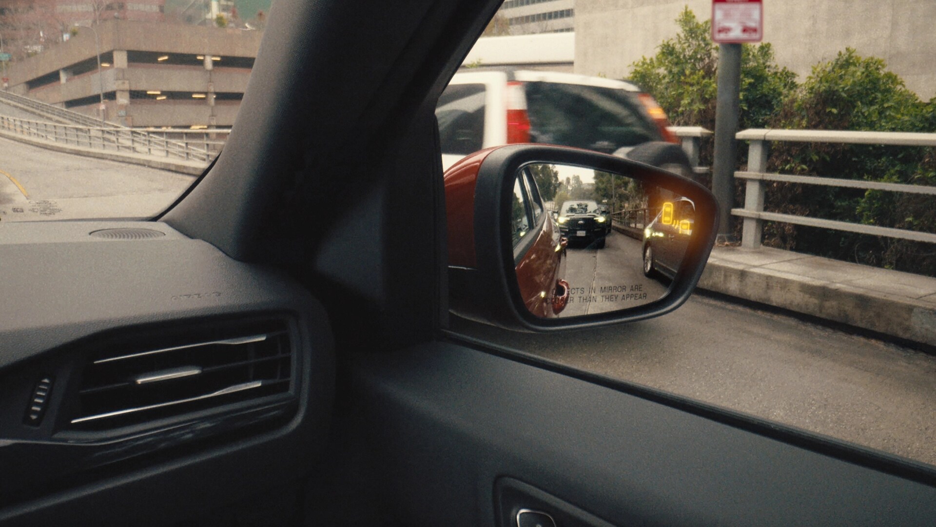 Close-up of sideview mirror showing Blind Spot Information System on the 2026 Ford Escape® SUV