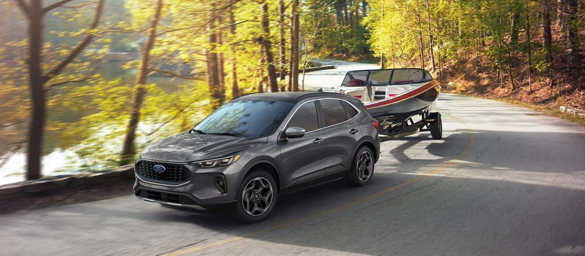 2026 Ford Escape® with 2.0L EcoBoost® engine towing a boat on a tree-lined road