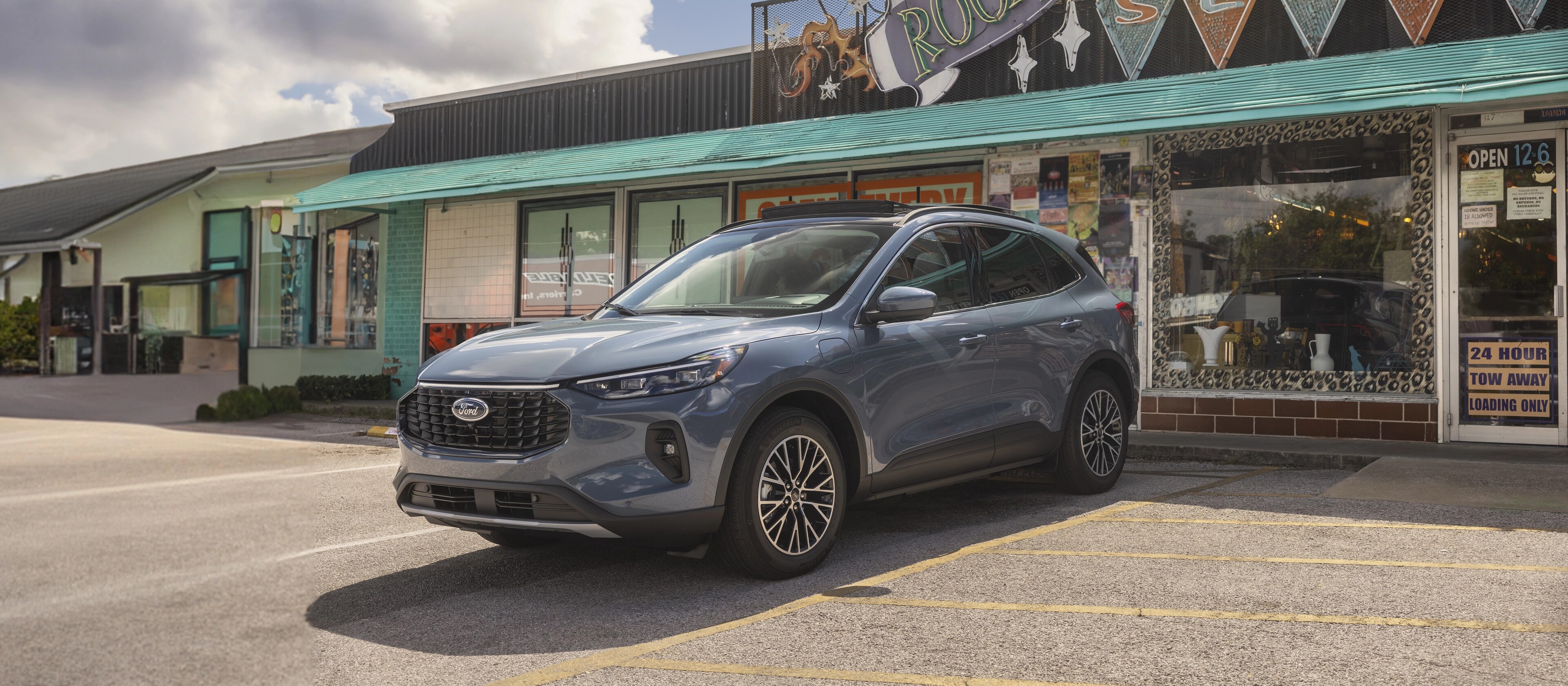 2026 Ford Escape® SUV parked in reverse outside a strip mall