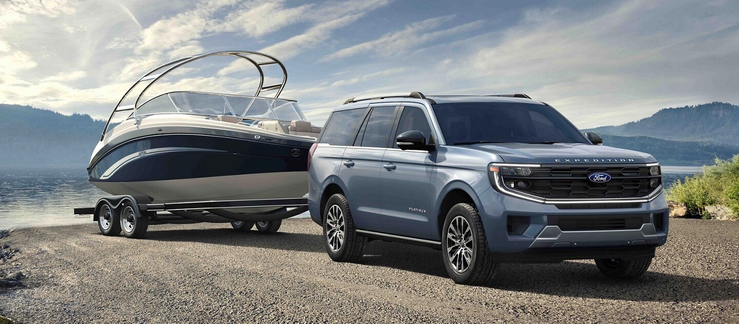 2025 Ford Expedition® model with a driver towing a boat on a trailer