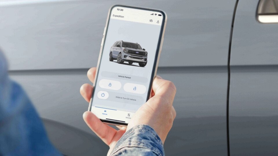 Person using the available FordPass® app with Phone As A Key function with a 2025 Ford Expedition® Platinum® SUV