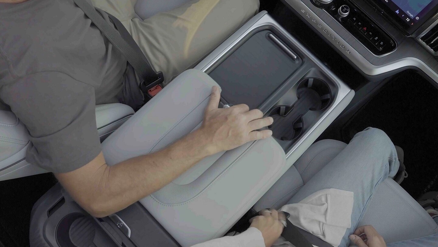 Two passengers in a 2025 Ford Expedition® SUV with the driver using the Flex Powered Console