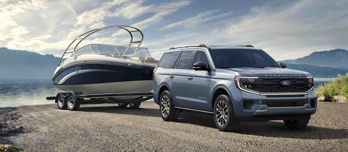 2025 Ford Expedition® model with a driver towing a boat on a trailer