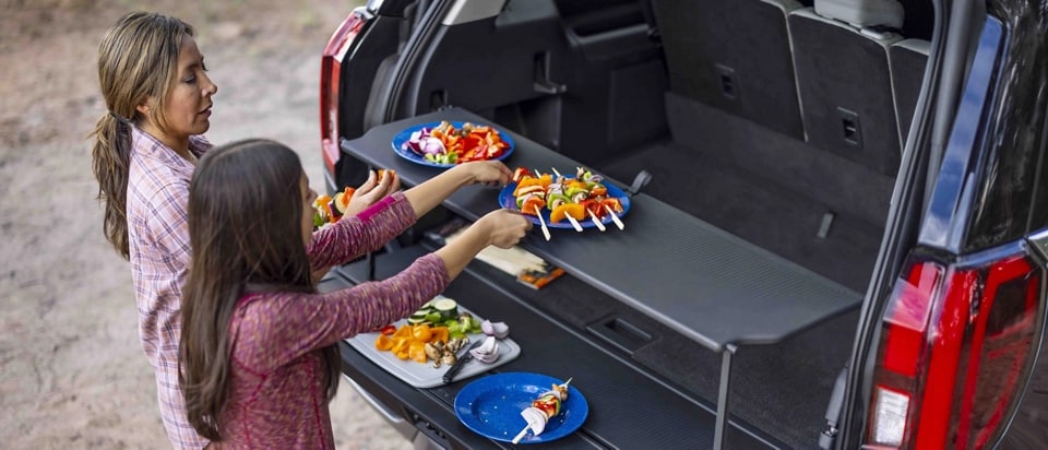 People using the Cargo Tailgate Manager in a parked 2025 Ford Expedition® SUV